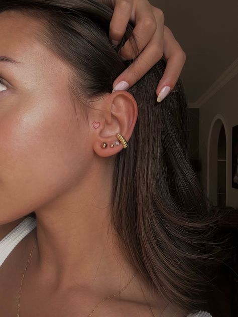 Ear Piercing Tattoo Ideas, Begging Ear Tattoo, Heart In Ear Tattoo, Minimal Tattoo Behind Ear, Beside Ear Tattoo Women, Small Tattoos On Ear, Front Of The Ear Tattoo Ideas, Tattoo Behind Ear Girl, Heart On Ear Tattoo