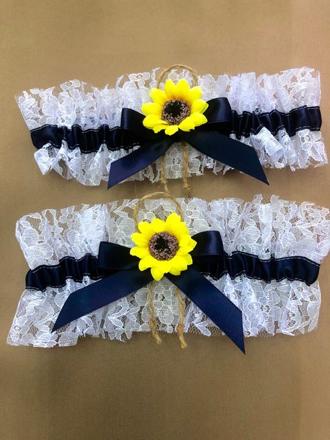 "I can customize with YOUR wedding colors. Created with 5/8\" wide navy blue double faced ribbon and white lace. Centered w/ coordinating ribbon, jute and sunflower. The smaller garter is 2.5\" wide, larger garter is 3.5\" wide. The set includes one of each. Garters relaxed are 14\" and stretch comfortably to 24\". Larger sizes may be made to order at no additional charge. Should you have any questions, please do ask." Western Garter, Blue Sunflower Wedding, Sunflower Wedding Cake, Wedding Western, Rustic Sunflower Wedding, Wedding Flowers Sunflowers, Bridal Garter Lace, Lace Garter Set, Forest Theme Wedding