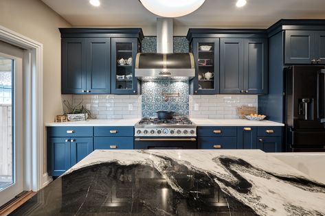 This kitchen in Fishtown, Philadelphia features Sherwin Williams rainstorm blue painted perimeter cabinets with Namib white quartzite countertop. An oak island with panda quartzite countertop includes apron front sink, trash pull out and open display cabinet. Brass hardware accents and black appliances are also featured throughout the kitchen. Blue Kitchen Black Appliances, Blue Kitchen Cabinets Black Appliances, Vermont Kitchen, Built In Microwave Cabinet, Nautical Office, Fishtown Philadelphia, Green Bedrooms, Contemporary Kitchen Remodel, Corner Base Cabinet