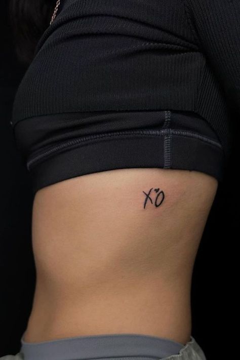 "Check out these tattoo ideas with 25 XO tattoos, bringing a gentle XO tattoo reminder of love and connection to your ink." The Weeknd Tattoo, Xo Tattoo, Smiley Face Tattoo, Record Label Logo, Ribcage Tattoo, Chic Tattoo, Dope Tattoos For Women, Cute Tattoos For Women, Hair Up Styles