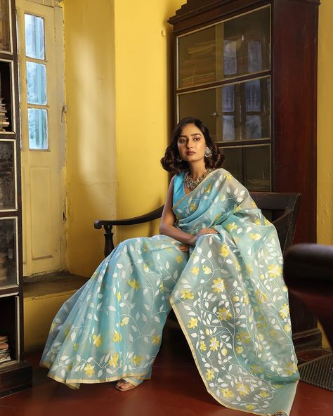 PRICE INR 50,000 अनुराधा - कहानी जामदानी की! The beauty of Muslin silk Jamdani sarees lies in the traditional craftsmanship that goes into their creation. Each saree is a labor of love, with skilled artisans dedicating hours to weaving intricate patterns by hand, ensuring a unique and timeless piece of art. [Luxury textile, Indian Textile, Kapaaskatha, Bengal weave, Jamdani, Story of India, Support artisans] This is a Blue Muslin Silk Jamdani Saree with beautiful flowers. The saree comes wi... Muslin Saree, Luxury Textiles, Jamdani Saree, Indian Textiles, Intricate Patterns, Fashion Sewing, Timeless Pieces, Labor, Beautiful Flowers