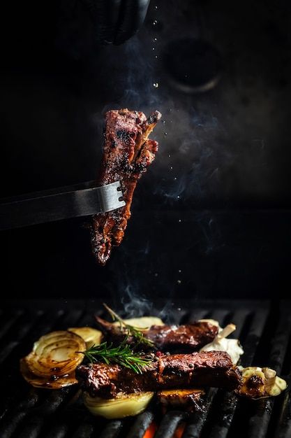 Premium Photo | Fork with pieces of delicious barbecued meat on black background Open Fire Cooking, Premium Meat, Sichuan Pepper, Fire Grill, Food Photoshoot, Hot And Spicy, Fire Cooking, Premium Food, Food Poster Design