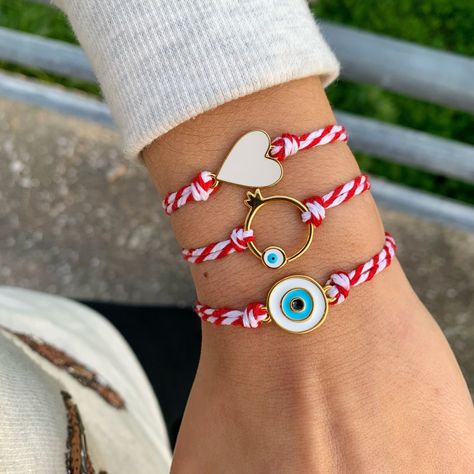 March Bracelets by Irene Andrea Jewelry *Well let's see Evil Eye's symbolism!  In many cultures, the evil eye is regarded as a symbol of Protection from the negative energy, while it attracts positivity! These bracelets, made of red and white cord, are called ''Martis''! In Greece we wear them from the beginning  to the end of March, as the tradition is that they are protecting us, so we will not get burned by the early spring sun of March! But off course, you can wear it also after March! If yo Greek Bracelet, Bracelets Evil Eye, Pomegranate Jewelry, Symbole Protection, Lucky Jewelry, Greek Evil Eye, Fun Bracelet, Bracelet Heart, Lucky Bracelet