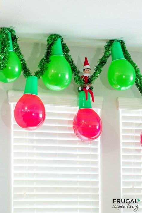 Make an adorable Christmas garland out of balloons and plastic cups in a few simple steps. Enjoy this Elf on the Shelf Balloon Garland and Elf on the Shelf Balloon ideas. This DIY balloon garland idea is quite adorable and adds instant Christmas decor to your cute elf idea. New Elf on the Shelf ideas daily plus free Elf on the Shelf printables. #FrugalCouponLiving #ElfontheShelf Elf On The Shelf In Balloon Ideas, Elf On The Shelf Ornaments Diy, Elf On The Shelf Brings A Gift, Willy Wonka Elf On The Shelf, Balloon And Solo Cup Christmas Lights, Elf On Shelf In Balloon, Elf Inside A Balloon, Elf On The Shelf With Balloons, Elf On Shelf Decorating Christmas Tree