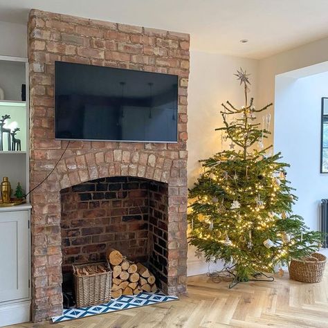 Sarah on Instagram: "Transformation Tuesday Christmas tree number 2 taking pride of place in the kitchen/family room beside the exposed chimney breast I regret not taking more before pictures of this room but if you swipe across, you’ll see a ‘during’ picture when we’d started to pull the plaster back, exposing this beautiful arch. A lot of graft by ourselves later and we’re super happy with the outcome A little secret I’ll share (& before you ask what colour it is), but this room is still Exposed Brick Fireplace Dining Room, Log Burner No Chimney Breast, Exposed Chimney Living Room, Exposed Brick Chimney Breast, Chimney Breast Decor, Exposed Brick Walls Living Room, Exposed Chimney, Brick Fireplace Log Burner, Front Living Room Ideas