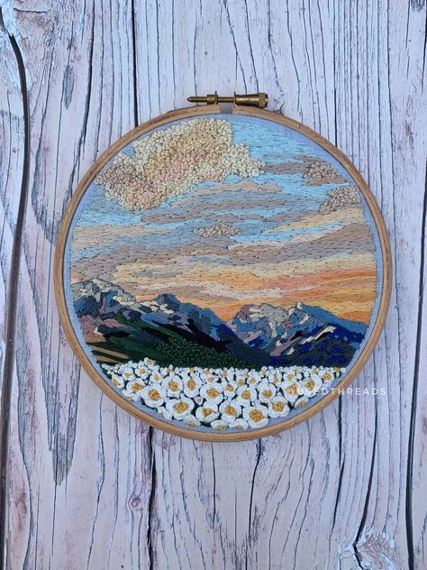 "6\" embroidery on blue linen. Thread painted mountain scene with a soft beautiful sunrise, dark mountain scape and quirky 3D floral field." Embroidered Mountain Scene, Knitted Landscape, Embroidered Mountains, Mountain Scape, Landscape Embroidery, Floral Field, Dark Mountains, Painting Pastel, Crafting Inspiration