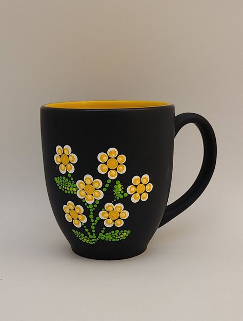 This listing is for one 12 oz hand painted coffee mug.  The mug is painted with a retro-style dot flower design.  The mug is black on the outside and yellow on the inside.   All mugs are hand painted to order, so each one is unique and may have slight variations in pattern. * * * * * * * * * * * * * * * * * * * * Care Instructions: Your Mug has been Hand-Painted with care, using Acrylic Enamel And heat Cured. To preserve the design and vibrancy of colors, please gently handwash in warm soapy water with a sponge. Avoid soaking, scrubbing, abrasive detergents, and excessive heat or steam * * * * * * * * * * * * * * * * * * * * *Please note: Items are hand painted to order, so there may be slight variations in color and design compared to picture. Custom color combinations are available! Plea Ceramic Mug Flowers, Diy Mug Designs Paint, Hand Painted Mugs Ideas, Paint Your Own Pottery Ideas Easy, Painting Coffee Mugs, Cute Mug Painting Ideas, Paint Your Own Mug, Easy Pottery Painting, Dot Mandela