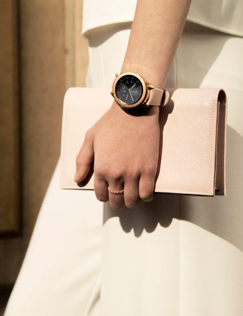 Left side of a woman in white holding a pink purse on a sunny day, wearing a 42mm Rose Gold Galaxy Watch on her wrist. Galaxy Smartwatch, Watch Aesthetic, Rose Gold Aesthetic, Gold Galaxy, Samsung Smart Watch, Fitness Trackers, Pink Watch, Smartwatch Women, Samsung Device