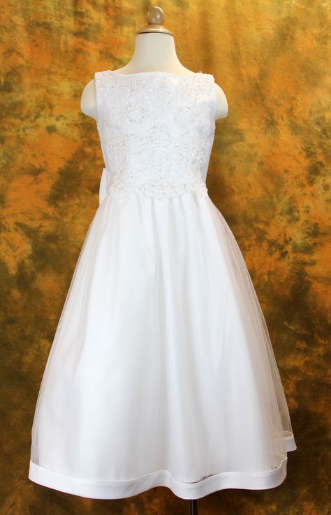 (6, White) This beautiful First Communion Dress was designed with the perfect complement of ornate meets simple elegance. The sleeveless Satin bodice has a neckline outlined with pearl beading and heavy all over beaded appliqués that cover the waistline beautifully. The plain tea length Tulle skirt features a dainty band at the hemline. The scoop back dress is outlined with matching beaded appliques and adorned with a stunning pre-tied bow at the lower back. A zipper closure completes the dr... Confirmation Dresses, Tea Length Tulle, Communion Ideas, First Communion Dress, Dress With Shawl, First Communion Dresses, Ribbon Belt, Communion Dresses, Beaded Applique