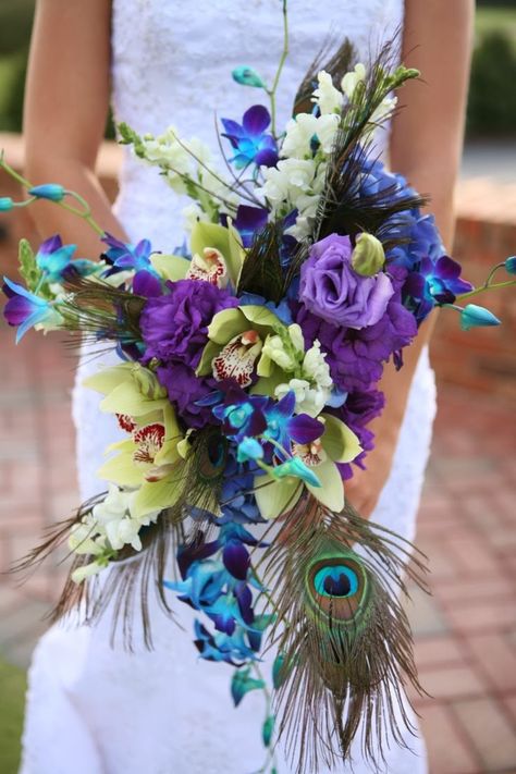 The peacock wedding is quickly becoming the hottest wedding trend ever ! Peacocks are considered a regal bird For some cultures it also symbolizes knowledge, kindness, patience and good fortune. With this kind of symbolism, it's no wonder it's... Wedding Bouquets Orchids, Peacock Wedding Flowers, Peacock Wedding Bouquet, Peacock Wedding Colors, Orchids Purple, Peacock Wedding Inspiration, Turquoise Bouquet, Peacock Wedding Invitations, Peacock Wedding Theme