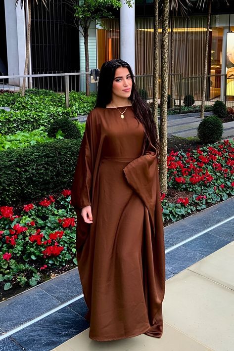 This Premium Chocolate Butterfly Abaya makes elegance and simplicity look easy! Crafted from luxurious fabric and precision-stitched, you'll feel as comfortable as you look stunning. Every detail of this classic silhouette has been carefully considered, while its inner lining adds a timeless touch. Transform your wardrobe with this effortlessly beautiful piece!- Premium High Quality Nidha- Discreet Inner Belt (Optional)- 100% Polyester (light weight and soft)- Model is 5'7 and wears a size 58- M Brown Abaya, Chocolate Butterfly, Silk Abaya, Abaya Mode, Butterfly Abaya, Eid Outfit Ideas, Abaya Dresses, Abaya Outfit, Eid Outfit