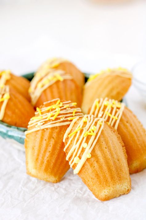 Check out this jazzy twist on a classic French dessert! We're making lemon madeleines, but throwing in some almond flour for texture and flavor. Then we'll dress up our mini cakes with a drizzle, sprinkles, and edible gold leaf accents. Get the recipe and tutorial from Bakes & Blunders! #spongecake #baking Madelines Recipe, Lemon Madeleines, Madeleines Recipe, Madeline Cookies, Madeleine Recipe, Madeleine Cookie, Edible Gold Leaf, Lemon Bar, Sponge Cakes