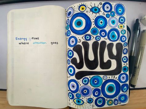 Bullet journal monthly spread for July. The word July is written in a bold bubbly font in the middle of the right page surrounded by various evil eye drawings and doodles. The left page includes the quote “Energy flows where attention goes” in a small font. Evil Eye Journal, Evil Eye Journal Page, Evil Eye Quotes, Eye Journal, Evil Eye Art, Eye Quotes, Doodle Pages, Painting Quotes, Bullet Journal Themes