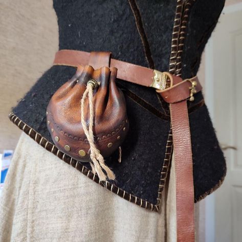 A small leather belt bag will go perfectly with your pirate, medieval or fantasy costume. You can put small necessary things in it. The purse bag is made of genuine cow leather 1.6 mm, has a size of 15.5 by 16 cm. It is made entirely by hand, from seams and embossing to dyeing and decoration. The bag is attached to the waist.  Attention! The belt on which the bag is photographed is not for sale! If you need a bag of a different color or size, write to me and I will make it to order) Pirate Bag Diy, Brown Leather Belt Bag, Pirate Bag, Fantasy Bag, Medieval Bag, Costume Pirate, Festival Costumes, Leather Belt Bag, Pirate Costume