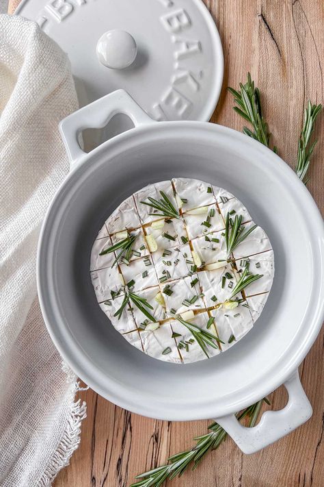 A ceramic brie baker sitting on a spalted maple serving board, filled with a wheel of brie cheese stuffed with garlic and rosemary sprigs, waiting to be put in the oven. Brie Appetizer Bites, Smoked Salmon Frittata, Brie Baker, Brie Cheese Recipes, Tomato Curry, Raw Garlic, Brie Recipes, Ceramic Baking Dish, Brie Cheese