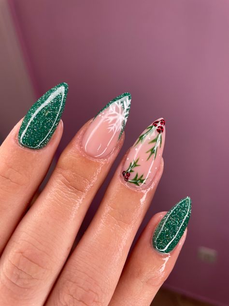 Woman nails with Christmas design in green colour Almond Winter Acrylic Nails, Mistletoe Acrylic Nails, Green Almond Nails Christmas, Winter Nails Not Christmas, December Green Nails, Mistletoe Nail Design, Green Mistletoe Nails, Christmas Almond Nails Green, Mistletoe Nails Christmas