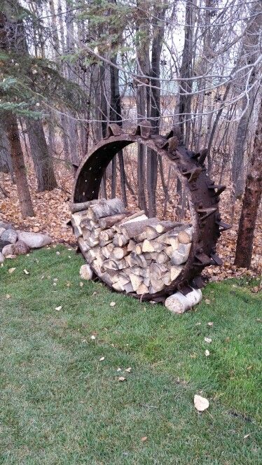 Tractor wheel, log holder. Reuse recycled Farm Equipment Repurposed, Tractor Wheel Fire Pit, Tractor Yard Art, Wheel Fire Pit, Farm Craft, Old Tractor, Log Holder, Tractor Parts, Reuse Recycle