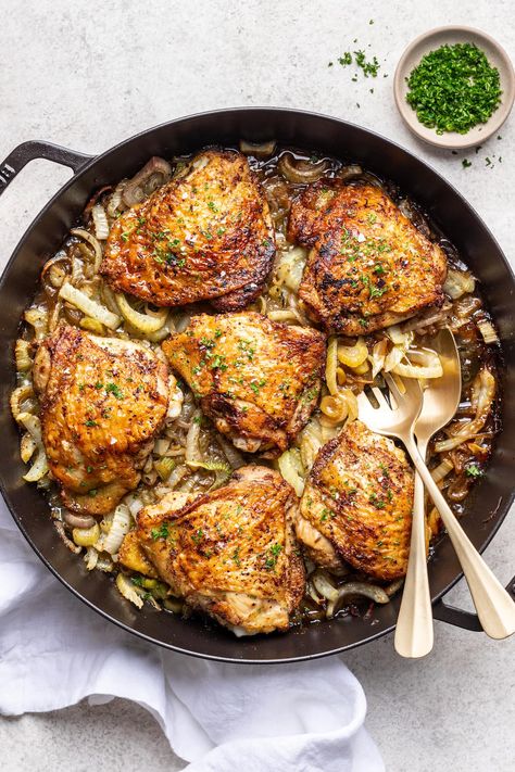 Tender and juicy Oven-Baked Chicken Thighs with fennel and shallots is an easy, flavorful weeknight dinner recipe that checks all the boxes! Dry-rub the chicken with toasted, ground spices, then pan sear to get that glorious crispy chicken skin. Bake in an oven on top of thinly sliced fennel and shallots (which become tender and sweet!), then serve with rice, potatoes, or couscous and your favorite veggie side dish. #wellseasonedstudio #chickenthighs #castironchicken #crispychickenthighs #... Crispy Chicken Skin, Oven Baked Chicken Thighs, Crispy Oven Baked Chicken, Simple Green Salad, Baked Chicken Thighs, Chicken Skin, Oven Baked Chicken, Weeknight Dinner Recipe, Veggie Side Dishes