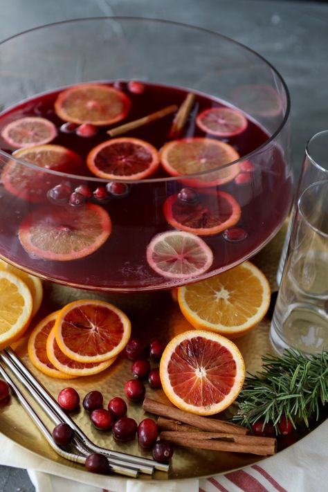 This easy spiked Thanksgiving Punch from The Whole Smiths makes a delicious and festive batch cocktail for a crowd to serve at your Thanksgiving celebration. You even have the option to add some CBD to bring the extra chill Thanksgiving vibes you may be needing. Simple yet delicious made with bourbon, amaretto, rosemary, lots of fresh citrus fruit and sparkling cranberry juice #thanksgivingrecipes #holidayrecipes #thanksgivingcocktail #punchrecipes #cbd Poinsettia Punch, Pomegranate Vodka, Vodka Punch, Thanksgiving Punch, Holiday Punch Recipe, Batch Cocktails, Holiday Punch, Thanksgiving Cocktails, Christmas Punch