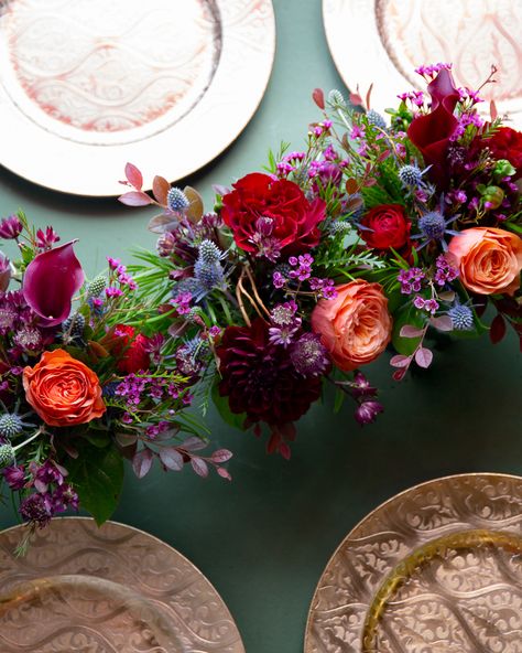 Artfully hand-designed, these three petite arrangements feature cranberry calla lilies, red roses, red ranunculus, burgundy dahlias, and peach roses in 4 inch cylinder glass vases. These arrangements are perfect for trailing along your table during your next fall gathering, or place it separately around the house to bring the rich hues of autumn indoors! Dimensions: Approximately 6" width x 5 1/2" height per vase Wedding Round Table Settings Colorful, Jewel Tone Wedding Flowers, Wedding Aisles, Jewel Tone Wedding, Fall Floral Arrangements, Wedding Entrance, Wedding Aisle, Wedding Napkins, Wedding Florals