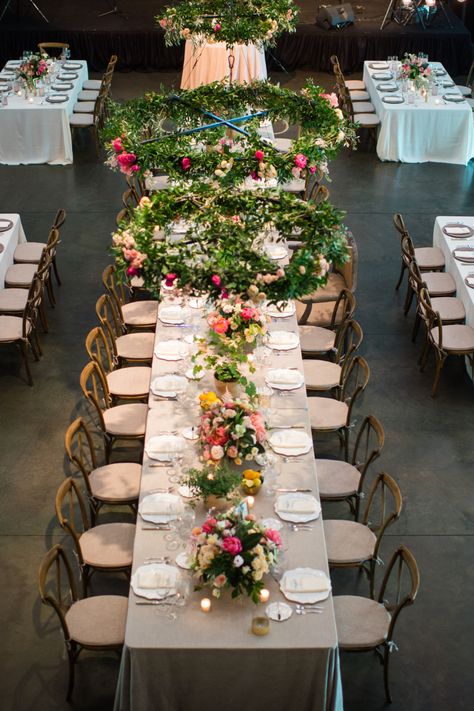 Add an enchanting and whimsical touch to your wedding reception with hanging floral rings. Adorn with greenery and florals in your wedding colors, such as pink and peach roses here. Place directly above the wedding party table for an elegant statement piece.  https://lovelessevents.com/ Summer Barn Wedding, Hanging Greenery, Southern Summer, Wedding Party Table, Peach Roses, Reception Decor, Wedding Reception Decorations, Party Table, Reception Decorations