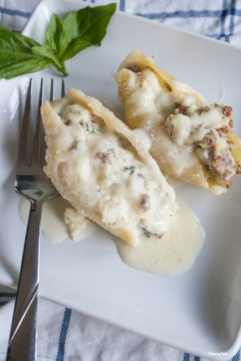 Italian Sausage Alfredo Stuffed Shells Italian Sausage Alfredo, Sausage Stuffed Shells, Italian Stuffed Shells, Stuffed Shells With Meat, Sausage Alfredo, Alfredo Stuffed Shells, Basil Mozzarella, Shell Pasta Recipes, Manicotti Recipe