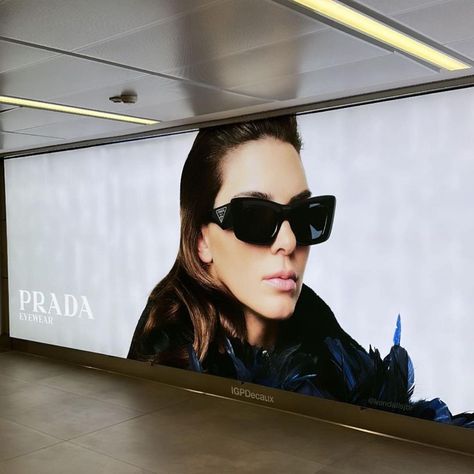 Billboard with a photo of Kendall Jenner promoting the Prada Eyewear campaign at Linate Airport in Milan, Italy. Kendall Jenner Campaign, Prada Billboard, Kendall Jenner Prada, Billboard Aesthetic, Billboard Model, Prada Photoshoot, Fashion Billboard, Prada Campaign, Kendall Jenner Modeling