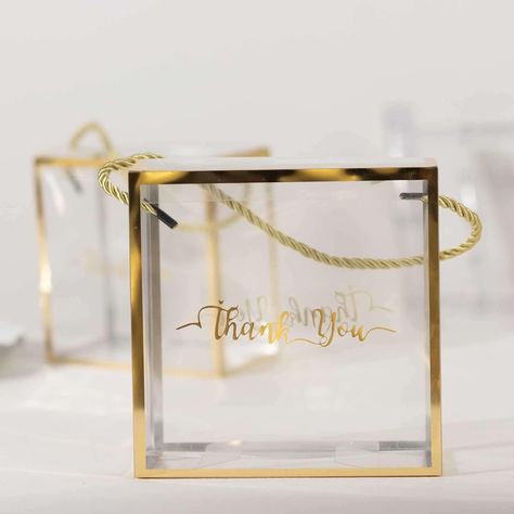 PRICES MAY VARY. Quantity: 25 Favor Boxes Material: Plastic Color: Clear with Gold Edges Style: Square Portable Box w/ Rope Handle Folded Size: 5.5"L x 3"W x 5.5"H Unfolded Size: 8.5"W x 11.5"H Rope Length: 13" Text: "Thank You" (on both sides) Thickness: 0.3mm Assembly Required: Yes. Easy to assemble. Boxes are shipped flat for easy storage Features: Premium Quality, Super Clarity, Handle for easy carry, Sturdy PREMIUM QUALITY: These favor boxes are made from high-quality premium material. This Party Favors For Adults, Party Setup, Transparent Box, Candy Gift Box, Event Gifts, Wedding Favor Boxes, Personalized Favors, Reveal Party, Baby Shower Balloons