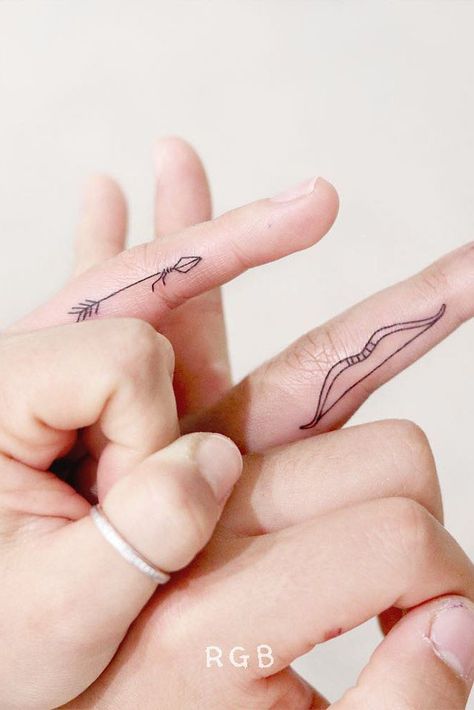 Matching Finger Arrow And Bow Tattoos #matchingtattoos #arrowtattoo Arrow And Bow, Unique Tattoos Black Women, Bow Tattoos, Cool Finger Tattoos, Couple Matching Tattoo, Ring Finger Tattoos, Bow Tattoo, Ring Tattoos, Arrow Tattoo