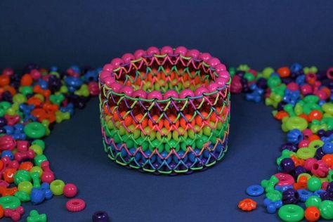 a striped rainbow cuff with opaque beads. it is on a dark blue backdrop surrounded by shaped neon beads. Ladder Stitch Kandi, Kandi Cuff, Kandi Bracelets, Ladder Stitch, Youtube Tutorials, Cuff, Rainbow