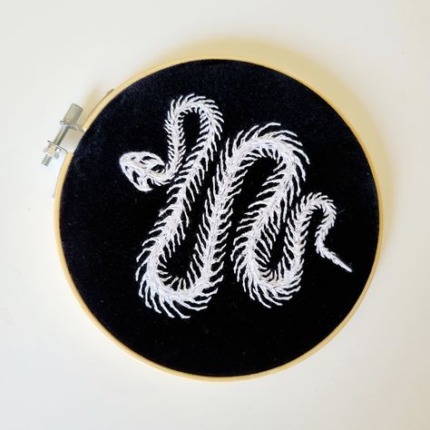 Unique Hand Stitched Snake Skeleton Embroidery on black velvet fabric Perfect spooky accent for any space or gift to a special person in your life. Finished in a gold vintage frame Easily hung on the wall with a thumb tack or places on a shelf. Thank you so much for stopping in to check out my stuff and possibly supporting my small business. It means so much. Please check out my other listings or follow my account on Instagram to keep up with my current creations! @thisstitchisbananas Made with Snake Skeleton Embroidery, Grunge Embroidery, Black On Black Embroidery, Moody Gallery Wall, Gothic Embroidery, Gold Vintage Frame, Spooky Embroidery, Skeleton Embroidery, Snake Embroidery