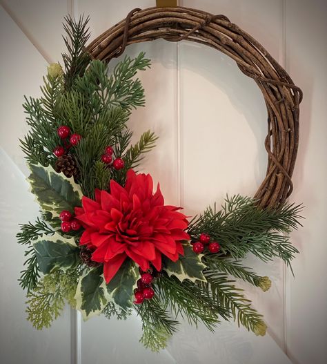 This 12" grapevine wreath is covered in realistic pine branches, red silk dahlia, berries and holly.  Bring in the holiday season with this eye-catching wreath in beautiful reds and greens.  This wreath has a finished size of 12"x15". Small Christmas Wreath, Thanksgiving Flower Arrangements, Pink Christmas Wreath, Contemporary Flower Arrangements, Fall Floral Decor, Red Dahlia, Holiday Wreaths Christmas, Holly Wreath, Beautiful Christmas Decorations