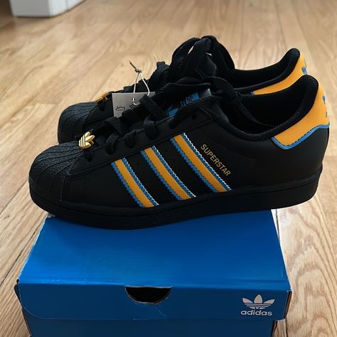 Shop kayleert24's closet or find the perfect look from millions of stylists. Fast shipping and buyer protection. Adidas Superstar J Black, gold, blue NWT and BOX Gold and blue shoe laces Converse Sandals, Jordans Aesthetic, Black Adidas Shoes, Adidas Shoes Originals, Custom Painted Shoes, Shoe Wishlist, J Black, Gold And Blue, Hype Shoes