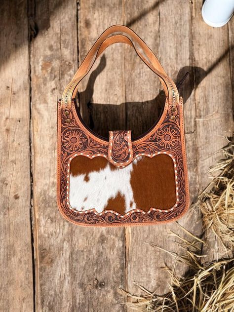 Classic Cowhide Purse - Timeless Western Elegance Add a touch of rustic sophistication to your everyday look with our Classic Cowhide Purse. Crafted from genuine cowhide leather, this timeless design exudes western charm and elegance. Features: - Made from high-quality, genuine cowhide leather - Classic western design with clean lines and simple silhouette - Spacious interior with multiple pockets for organization - Durable and long-lasting construction - Distressed leather finish for a unique, vintage look Measurements: 13x17x4" Cowhide Purse, Timeless Classic Style, Western Design, Distressed Leather, Backpack Purse, Looks Vintage, Cowhide Leather, Leather Purses, Vintage Looks