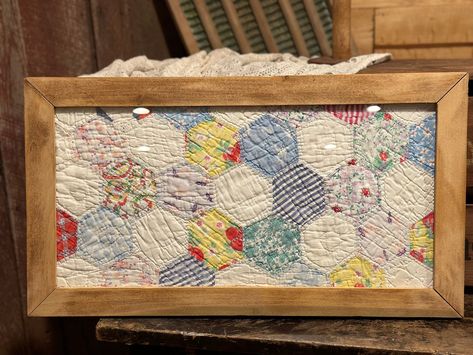 This sweet vintage quilt is framed in a repurposed wood frame. the original quilt was too damaged to repair, so I framed it so this treasure can still be enjoyed. The quilt is made with colorful and delicate fabric. This piece comes ready to hang, with hardware on back. Glass in place in front of quilt. This piece would make a beautiful gift or addition to any home! Quilt Wall Decor, Vintage Quilt Coasters, Framed Quilts Wall Hangings, How To Display Quilts In Your Home, Quilt Repurpose Ideas, Old Fabric Diy Reuse, Vintage Quilt Crafts, What To Do With Old Quilts, Repurposed Quilts Ideas