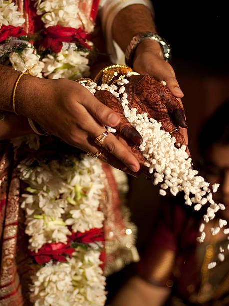 The bride and the groom together offering parched rice into the... Telugu Brahmin Wedding, Bengali Marriage, Post Wedding Photoshoot, Brahmin Wedding, Indian Wedding Aesthetic, Bengali Aesthetic, Temple Wedding Photography, Indian Wedding Pictures, Bride Groom Photoshoot