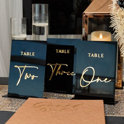 Modern Black Acrylic Wedding Table Number With Mirror Gold Numbers EWSGT021 Modern and sophisticated touch to the decor. The smooth surface provides an ideal canvas for intricate designs, elegant calligraphy, or minimalist numbering. Wedding Personal Touches, Wedding Seating Chart Display, Table Numbers Wedding Elegant, Inexpensive Wedding Invitations, Acrylic Wedding Sign, Gold Table Numbers, Wedding Champagne Glasses, Dinner Table Decor, Wedding Table Number