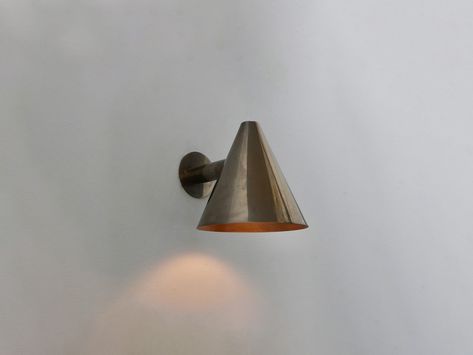 art deco copper wall light, outside wall lights, indoor sconce design, mcm exterior wall sconce, minimal wall outdoor light, simple outdoor wall light, unique outdoor sconce lamp, outdoor copper sconce lighting, outdoor lights wall mount This cone-shaped wall sconce is a great choice for your room. The cone shape helps the light spread while staying focused. The polished finish makes it look like an antique item. This easily becomes your room's interior decoration and light source. Place it in your bedroom, living room, reading room, bathroom, or office to give the surroundings a warm, nostalgic touch. This cone copper wall sconce suits an industrial or minimalist house style. It's also available in various finish colors; choose the one that suits you best! Product Specs: ✦ Material: Coppe Scandinavian Exterior Lighting, Crete House, Mcm Exterior, Scandinavian Wall Lighting, Scandinavian Exterior, Modern Bedroom Wall, Wall Light Design, Bedroom Wall Lamp, Lighting Mid Century