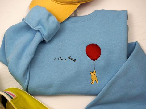 Winnie the pooh embroidered sweatshirt. Based on the original illustrations from the classic book. These are unisex and make great oversized sweatshirts.  See the size chart in the photos to ensure a good fit.     -50/50 cotton/polyester fleece  -Pre-shrunk -pill-resistant fleece blend The Embroidery Geek is a custom embroidery studio in Pennsylvania. All of our items are designed and made to order in-house on a commercial embroidery machine. If you have any questions please don't hesitate to co Embroidery Sweatshirt Disney, Crewneck Sweatshirt, Disney Hoodies Embroidery, Winnie The Pooh Crewneck Nike, Winnie The Pooh Nike Sweatshirt, Winnie The Pooh Hoodie, Winnie The Pooh Embroidered Sweatshirt, Commercial Embroidery Machine, Vintage Parisian