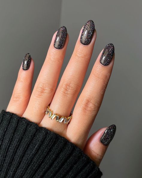 Posted by Zoe Scott: Step into the world of Black Glitter Nails, where edgy glam meets timeless style. Get ready to elevate your look with a touch of sparkle. In this blog... Check more at https://alexie.co/beauty/latest-black-glitter-nail-designs-to-try-today/ Black Nails With Sparkles, Black Glitter Almond Nails, Black Glitter Nail Designs, Glitter Almond Nails, Black Sparkle Nails, Black Glitter Nails, Glitter Nail Designs, Black Ombre Nails, Black French Nails