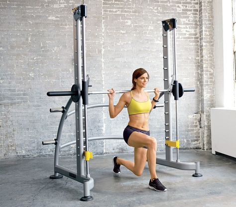 Why it's a winner You can knock out squats, presses, chin-ups and more all in one spot. Tackle it Use a weighted lunge to superspeed your lower-body sculpting results: Load a 10-pound plate on each end of bar. Stand in center of machine with bar resting against shoulder blades, feet staggered, right foot in front. Lift bar off metal pegs so body supports the weight, and bend knees 90 degrees, keeping right knee in line with ankle (as shown). Return to start. Do 12 reps; return bar to pegs, then Room Activities, Fitness Board, Weight Room, Gym Machines, Cardio Training, Body Support, I Work Out, Fitness Equipment, Weight Training