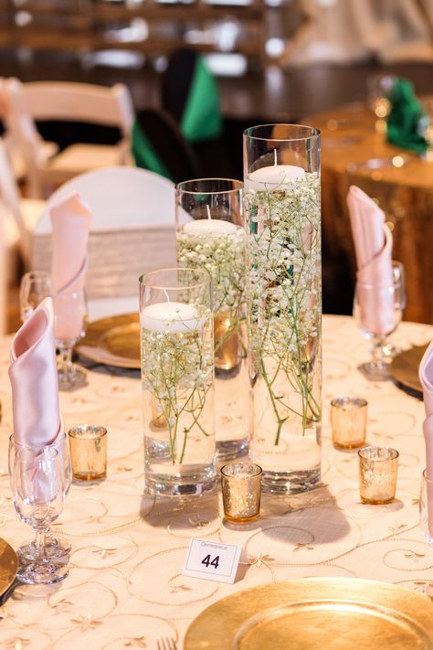 Centerpiece created by Ceruti's Floral and Decor Team! Photography: Gem Photography #fortwayneweddingflowers #babysbreath #floatingcandles #mercuryglass #rusticwedding #blushwedding #weddingdecor #weddingcenterpiece #fortwayneweddings Small Floating Candle Centerpieces, Center Piece With Candle, Babysbreath Centerpieces Vases, Simple And Elegant Centerpieces, Babysbreath Centerpieces With Candles, Clear Orbeez Centerpieces Wedding, Candle Vase Centerpieces, Water Centerpiece Wedding, Candle And Mirror Centerpieces Wedding