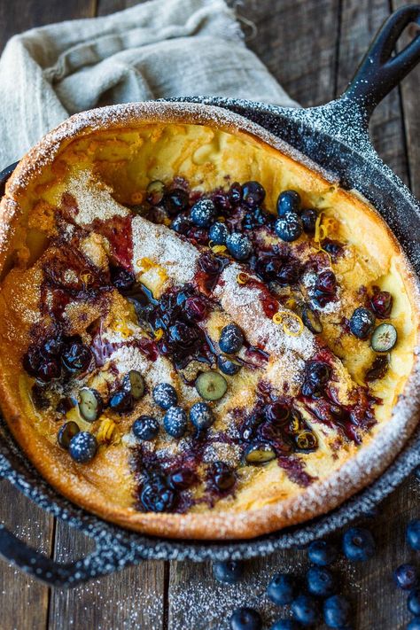 Delicious and impressive Blueberry Dutch Baby is made with everyday pantry ingredients and requires only about 10 minutes of hands-on time! Top with maple blueberry sauce for a perfect brunch or dessert. Omlete Recipe, Blueberry Dutch Baby, Blueberry Clafoutis, Dutch Baby Pancakes, Baby Pancakes, Dutch Baby Pancake, Iron Chef, Dutch Oven Recipes, Perfect Brunch