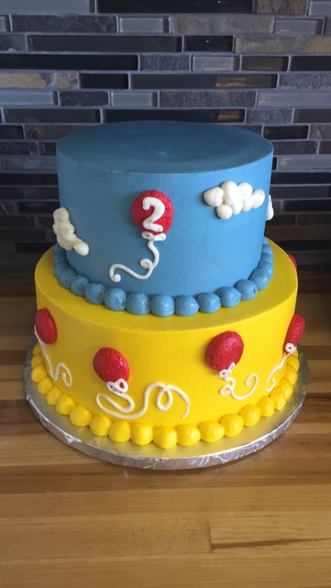 2 tier birthday cake blue and yellow with red balloons white fluffy clouds and borders 2 Tier Birthday Cake, Number One Cake, Tier Birthday Cake, Yellow Birthday Parties, Peppa Party, Balloons White, Candyland Theme, Blue Birthday Cakes, Tiered Cakes Birthday