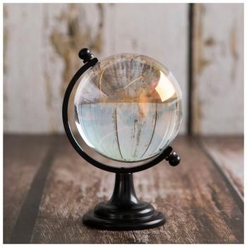 Dimensions: 4.8" H x 3.15" W x 3.35" D Material: Glass & Metal Color: Clear & Black Care & Safety: Decorative Use Only Quantity: 1 Fill your home with pieces inspired by your travels, such as this Glass Globe. This piece features a glass sphere sitting in a metal stand with a round base, which gives it a globe-like appearance. Place this in your office with other modern decor for a look that ties the space together with its shape and style! Small Globe Decor, Home Decor And Accessories, Globes Decor, Interior Design Christmas, Globe Diy, Christmas Home Decorations, Globe Crafts, Glass Sphere, Globe Decor