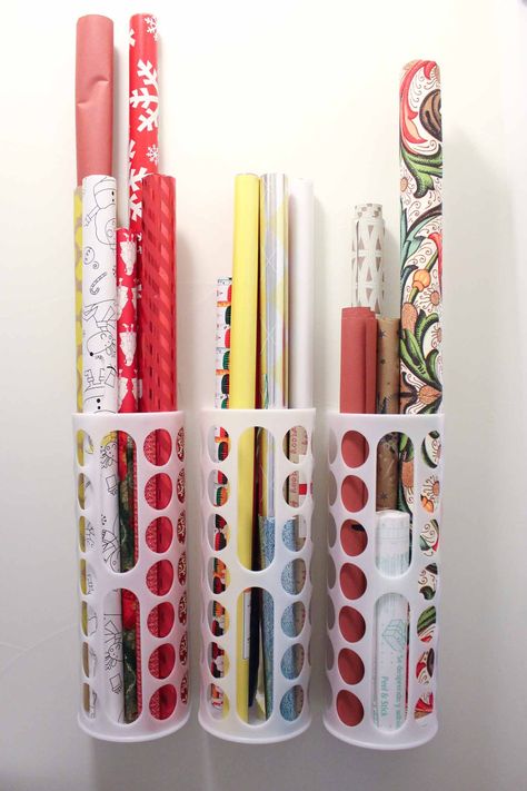 Create this simple DIY wrapping paper storage idea using Ikea's Variera plastic bag dispensers. Get those crazy rolls of gift wrap up off the floor and contained in a tidy system! Click for details on measuring and hanging for this Ikea hack. | MakeAndDoCrew.com Diy Wrapping Paper Storage, Tissue Paper Storage, Wrapping Paper Organization, Gift Wrap Organization, Kennel Ideas, Craft Paper Storage, Diy Wrapping Paper, Plastic Bag Storage, Wrapping Paper Storage