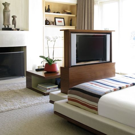 Pop-up tv cabinet in walnut with integrated bench & upholstered bed. Talking Tables coffee table in background in Oriental wood & lacquer. #tvpopup #customcabinetry #interiordesign#customupholstery #bed #custombed Modern Pop Up Tv Cabinet, Tv In Front Of Bed, Tv Cabinet Ikea, Pop Up Tv Cabinet, Tv Lift Cabinet, Tv Bed, Tv Wall Cabinets, Tv Lift, Tv Cabinet Design