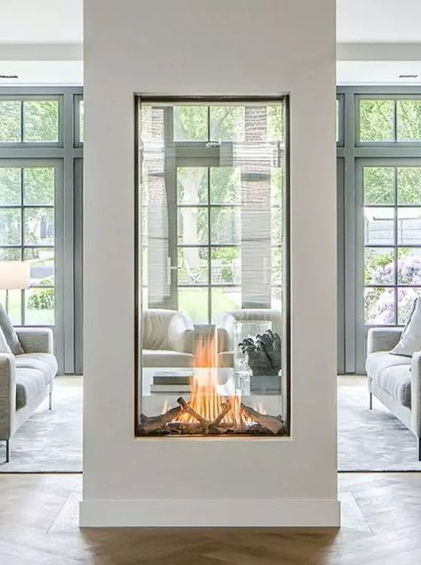 a two sided fireplace with glass will provide two spaces with a beautiful fire look and with coziness and chic Modern Glass Fireplace Ideas, Glass Fireplace Ideas, Three Sided Fireplace Ideas, Fireplace Under Window, Two Way Fireplace, Through Fireplace, Window Fireplace, Fireplace Windows, Two Sided Fireplace