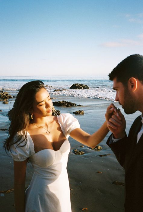 Italian Inspired El Matador, Malibu Engagement Shoot Beach Dress Engagement Photos, Engagement Shoot At The Beach, Malibu Engagement Shoot, White Dress Beach Photoshoot Couple, Malibu Engagement Photos, Italian Engagement Photos, White Dress Engagement Pictures, Ocean Elopement, Engagement Photos Italy