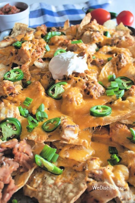 Sheet Pan Chicken Nachos are great for an appetizer, lunch or even dinner. Chicken, beans, cheese, and jalapenos all on tortilla chips. Making these nachos all on a sheet pan makes them easy to throw together when you are in a hurry. Sheet Pan Nachos With Refried Beans, Chicken Nachos Sheet Pan, Nachos Sheet Pan, Shredded Chicken Nachos, Sheet Pan Nachos, Pan Nachos, Chicken Beans, Chicken Nachos Recipe, Easy Nachos